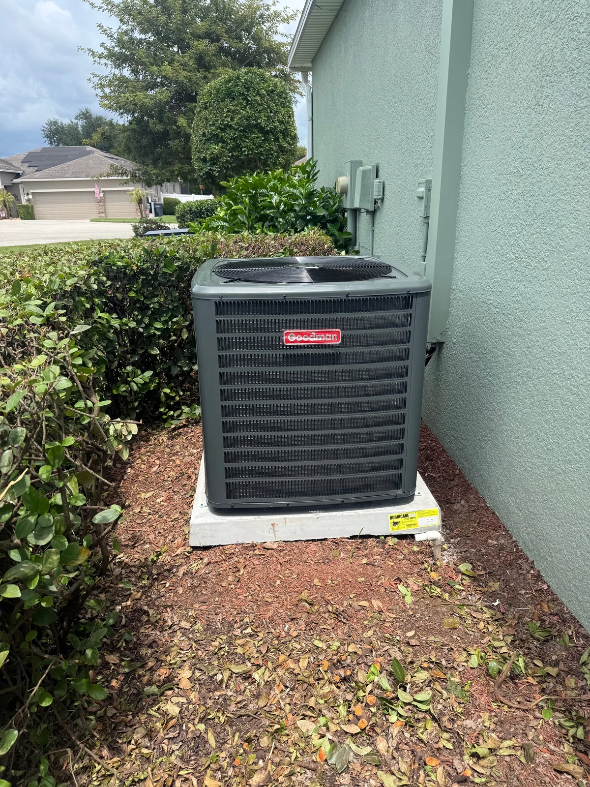 High-efficiency AC condenser installed beside a Lakeland FL home by Anchored A/C & Heating