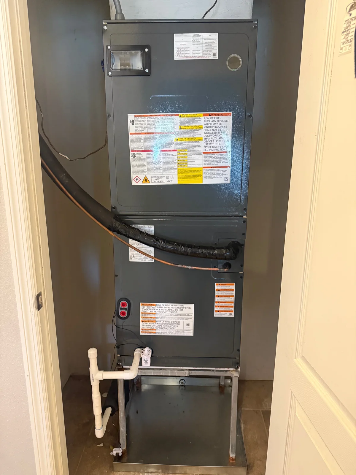 Indoor air handler and refrigerant lines installed by an Anchored A/C & Heating technician in a Polk County FL home