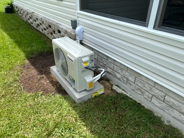 Ductless mini split outdoor unit installed beside a home by Anchored A/C & Heating in Polk County FL